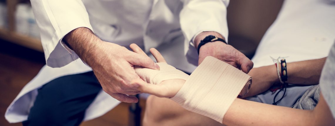 doctor wrapping patient wrist