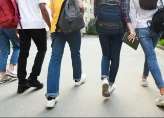 Teenagers with backpacks walking
