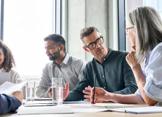 Adults discussing around a table