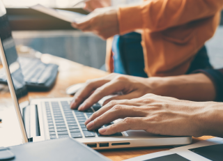 hands working on a computer