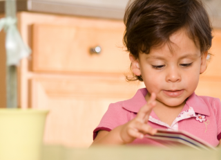 Early Learning student reading a book
