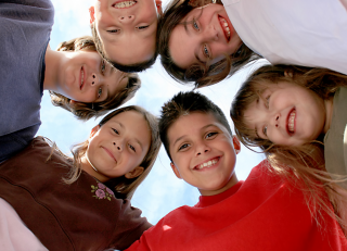 Students smiling in a circle