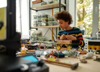 Girl working with parts for a robot