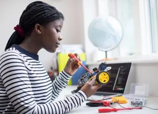 Girl working on a robotics project.