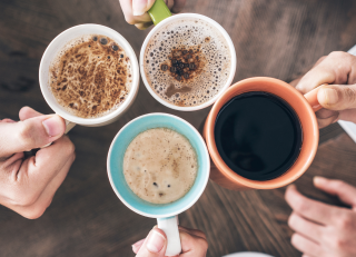 four hands holding coffee