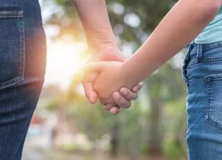Parent and child holding hands