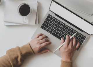 Image of hands working on a laptop